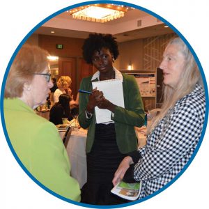 3 women talking at an event